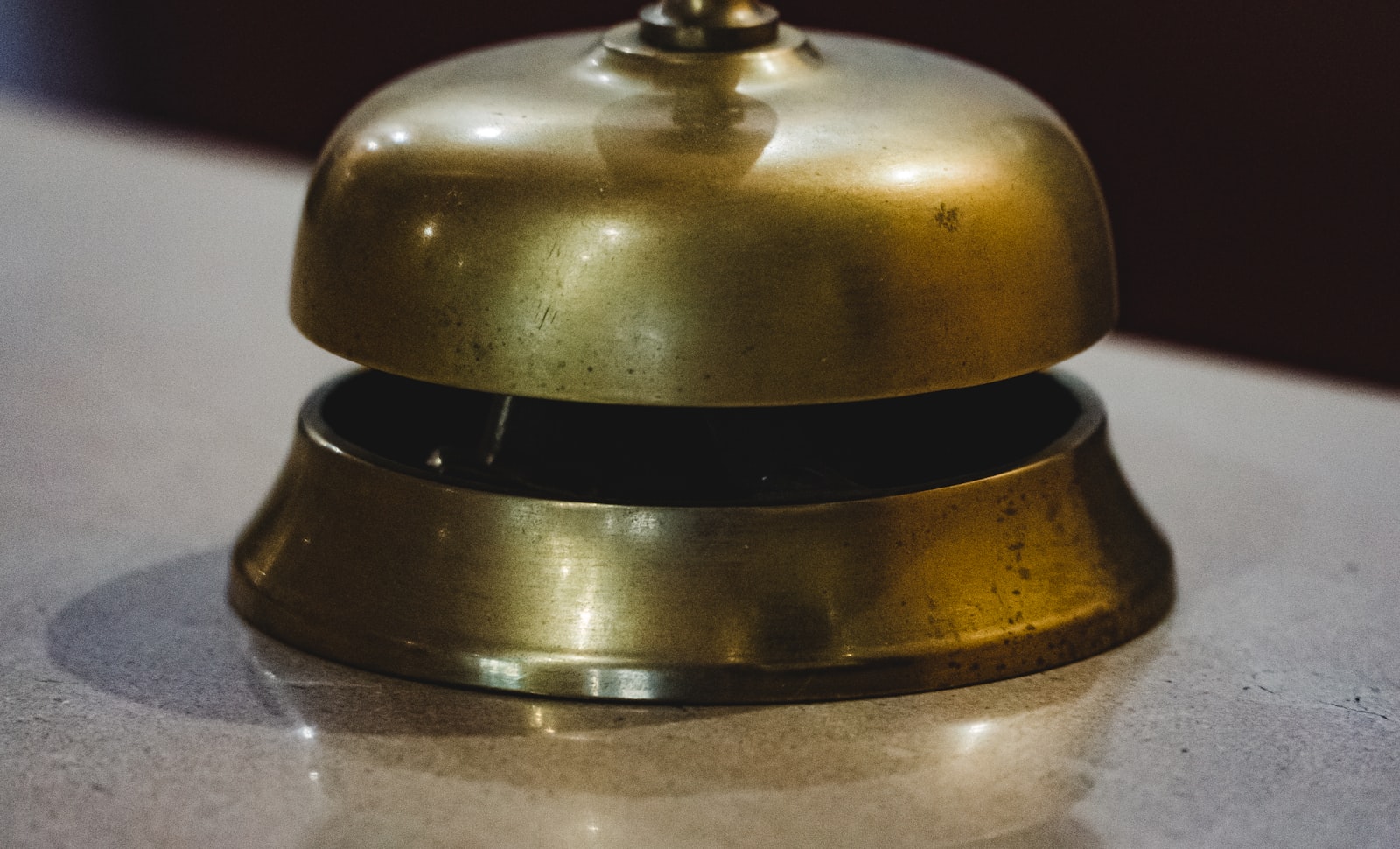 A brass service bell on a counter