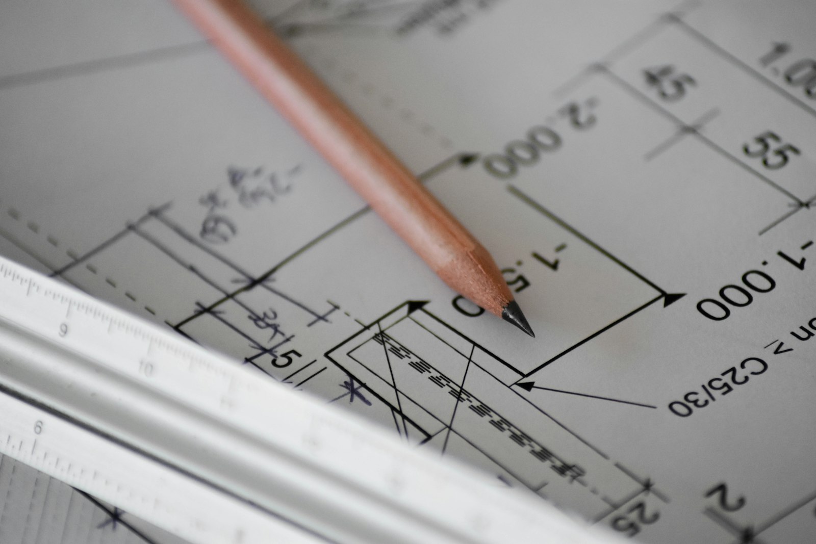 Pencil and ruler resting on an architectural drawing
