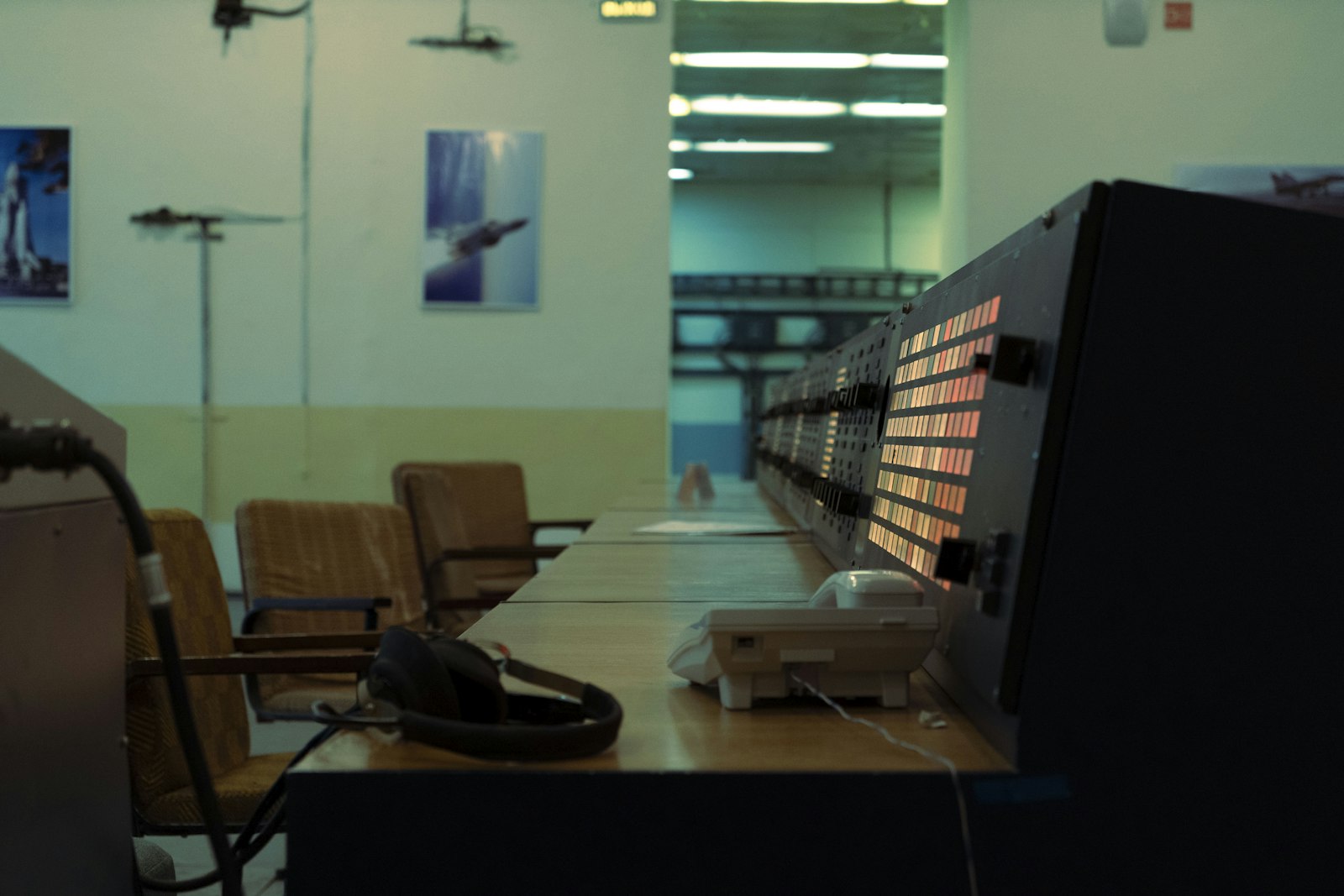 Rows of consoles and switchboards in a vintage control room
