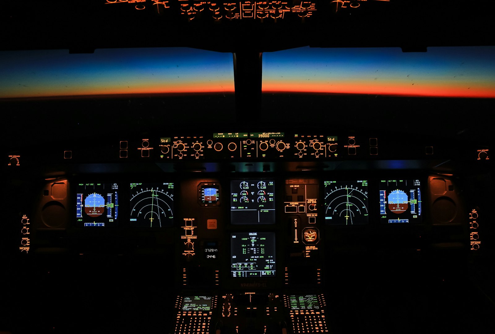 Airliner cockpit at dusk, instrument panels lit, autopilot flying